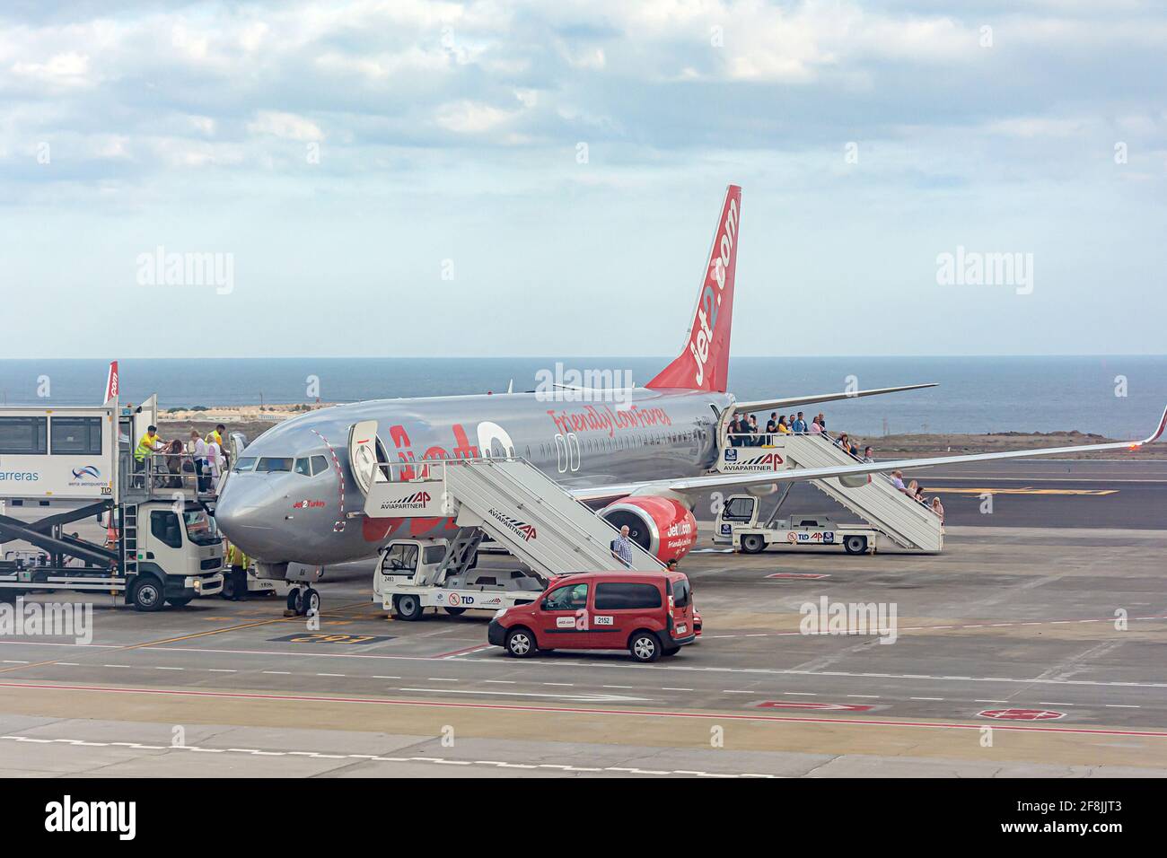Tenerife, Spain - March 21, 2021: Passengers exit the plane with the inscription Friendly Low Fares. Stock photo. Stock Photo