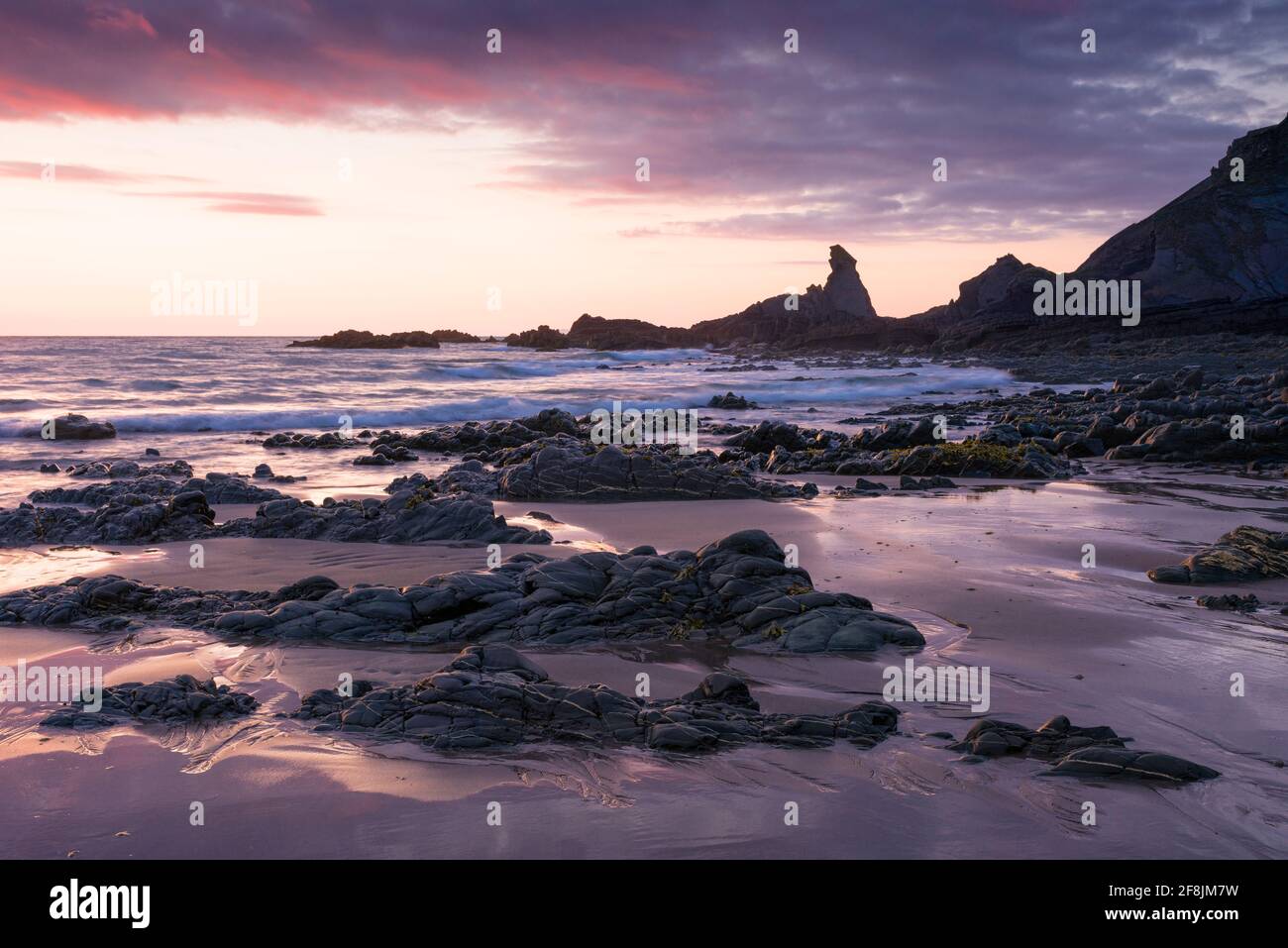The exposed beach during low tide at Hartland Quay in the North Devon Coast National Landscape at dusk, England. Stock Photo