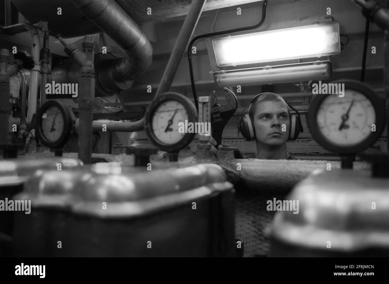 Lightermen of the River Thames working on the barges. Engine room