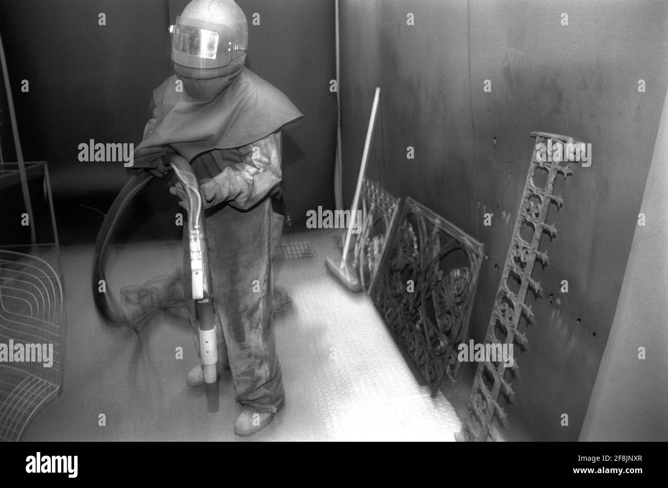 Sandblasting Radiators High-Pressure Washer Sand Blasting a radiator in an enclosed workshop ...