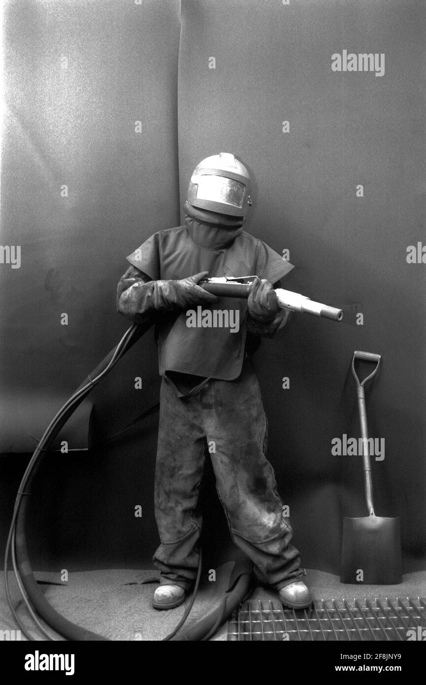 Sandblasting Radiators High-Pressure Washer Sand Blasting a radiator in an enclosed workshop ...