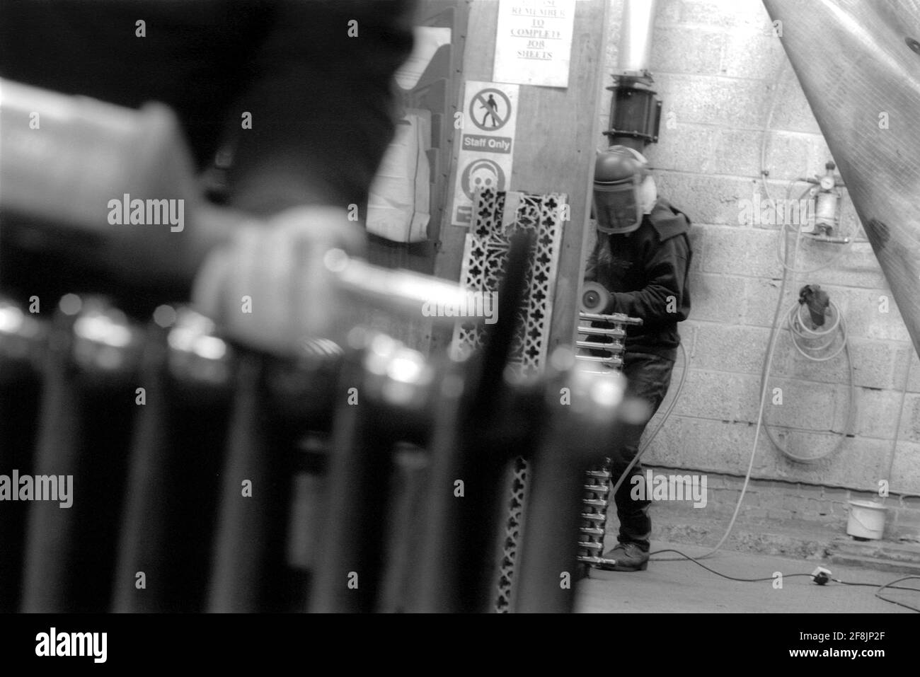 Sandblasting Radiators High-Pressure Washer Sand Blasting a radiator in an enclosed workshop ...