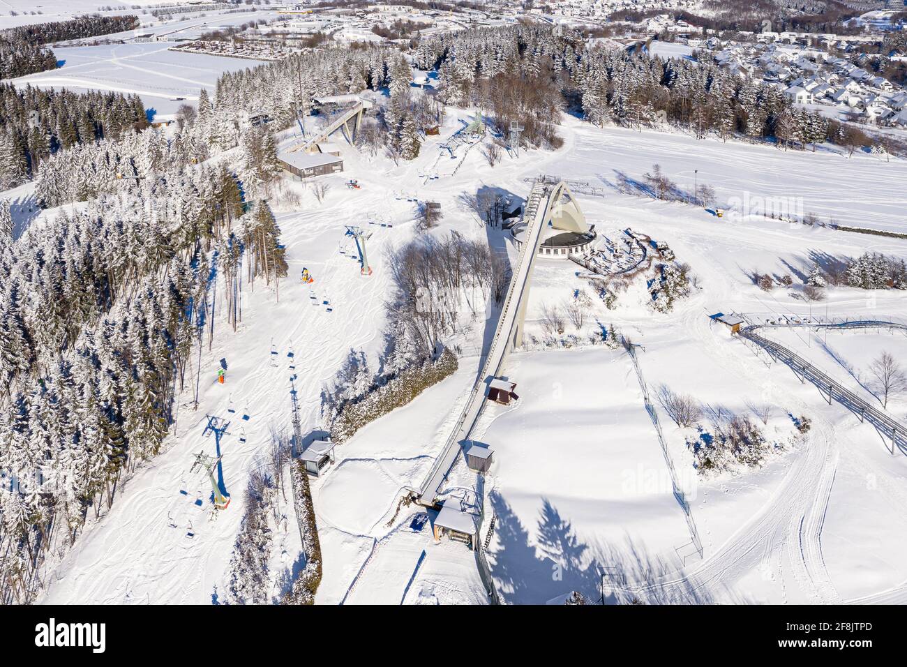 The Saint George ski jump and the ski slopes from the ski lift Carousel Winterberg photographed from the air. In the beautiful winter weather the wint Stock Photo