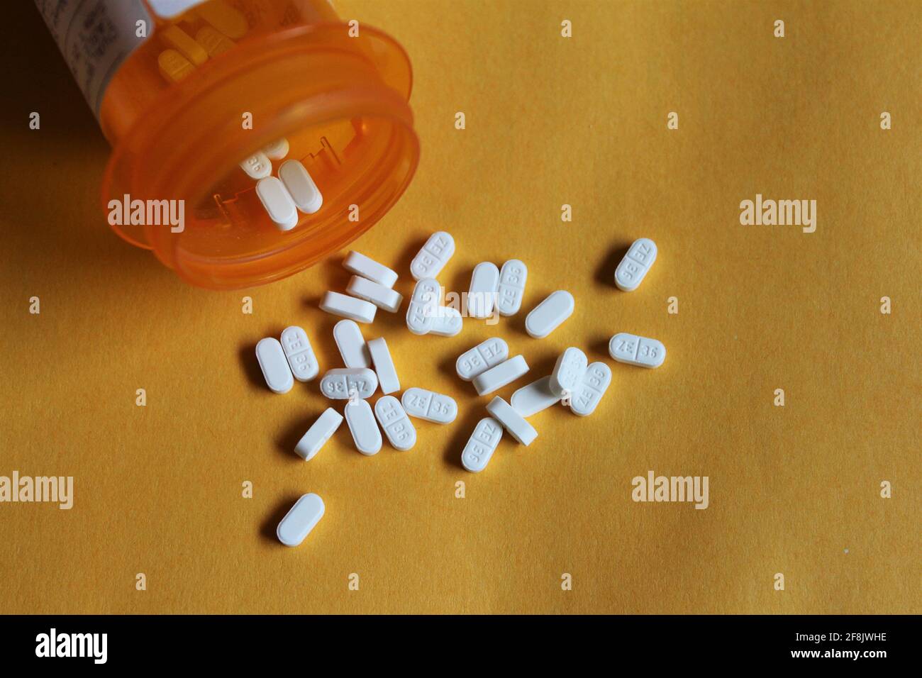 Buspirone HCL pills laying flat on a yellow background. Medication used to treat anxiety.  It may also help you feel less jittery and irritable Stock Photo