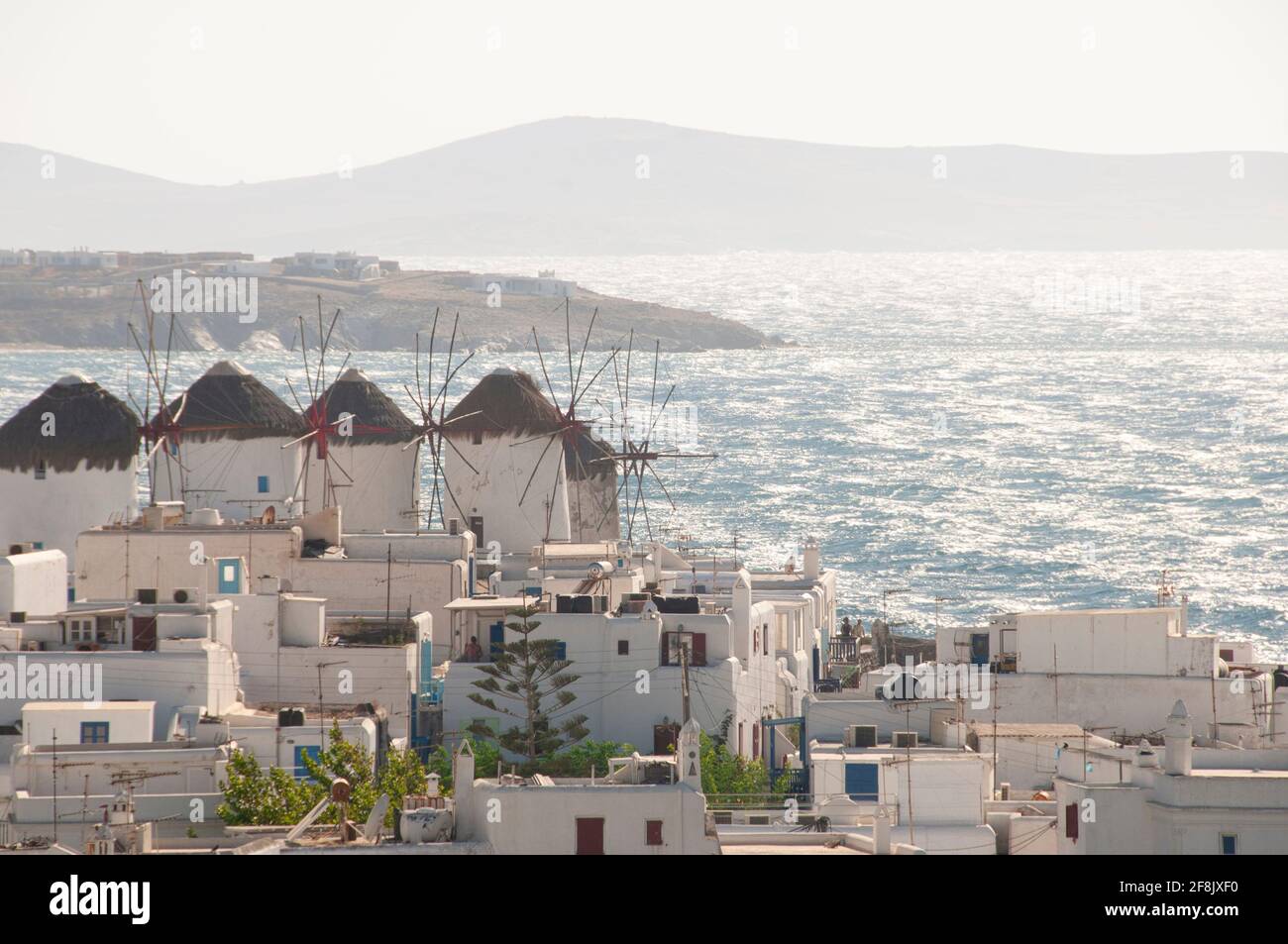 Panoramic view of Mykonos island village (Chora) with traditional Cycladic houses, windmills, and the Aegean Sea in the background Stock Photo