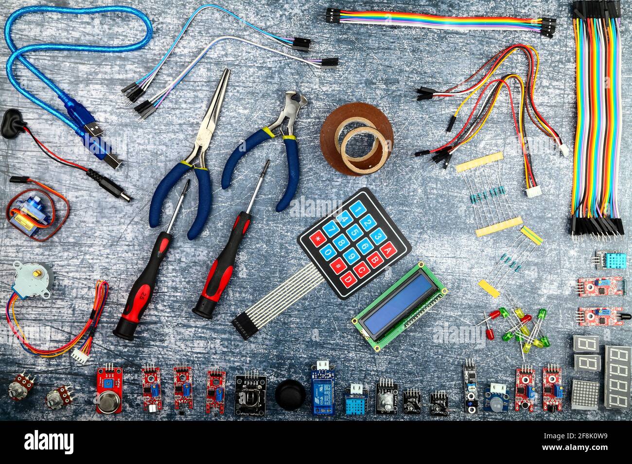 Arduino uno and electronic components flatlay on a blue rustic background Stock Photo