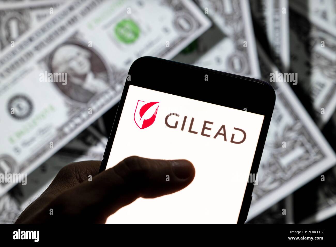 China. 27th Mar, 2021. In this photo illustration, the American biotechnology company Gilead Sciences logo is seen on an Android mobile device screen with the currency of the United States dollar icon, $ icon symbol in the background. Credit: Chukrut Budrul/SOPA Images/ZUMA Wire/Alamy Live News Stock Photo