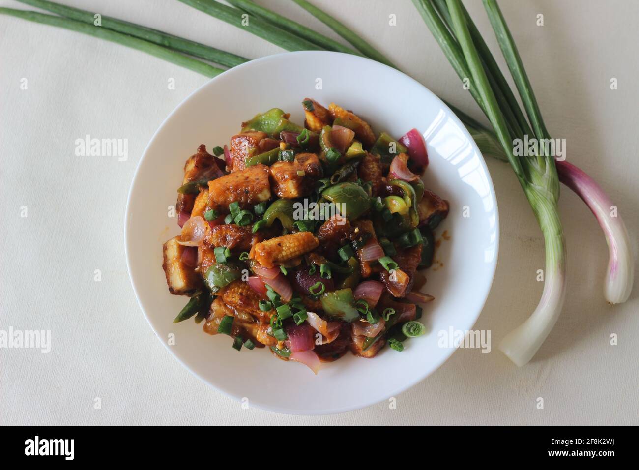 Air fried cottage cheese cubes and baby corn prepared with chilli sauce
