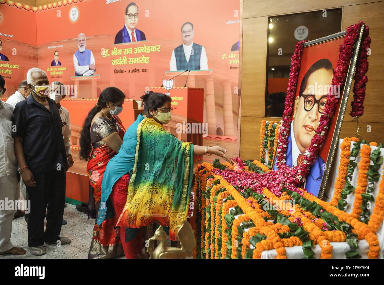 New Delhi, India. 14th Apr, 2021. People pay floral tributes to the portrait of Bharat Ratna Baba Sahab Bhim Rao Ambedkar on his birth anniversary, at BJP party headquarter in New Delhi. The nation is celebrating the 130th birth anniversary of Dr. B.R. Ambedkar, the architect of Indian Constitution. He campaigned against social discrimination towards the untouchables (Dalits), all his life he worked for the welfare of the poor. Credit: SOPA Images Limited/Alamy Live News Stock Photo