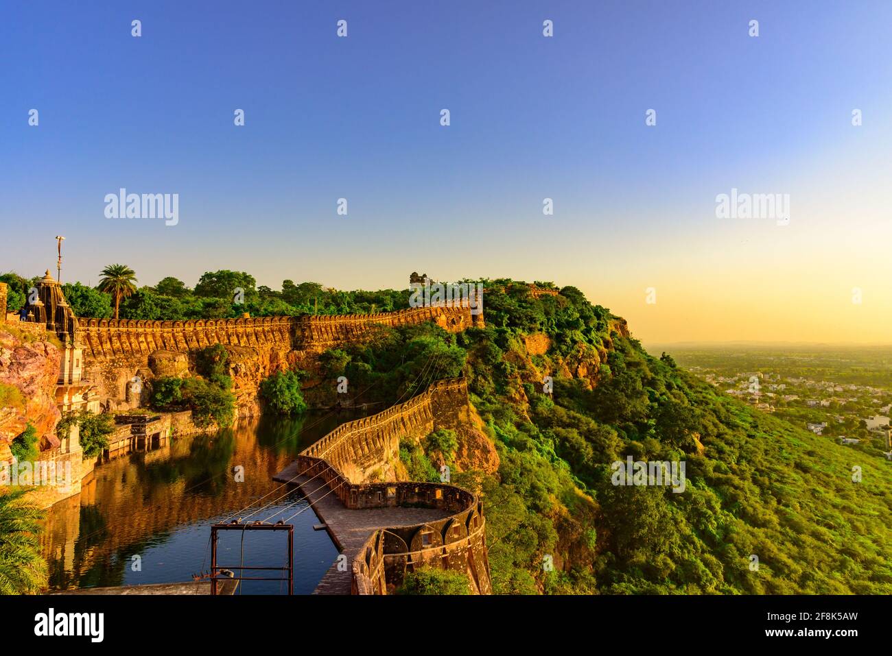 View during sunset from Chittor or Chittorgarh Fort with city in backdrop. It is one of the largest forts in India &  listed in the UNESCO World Herit Stock Photo