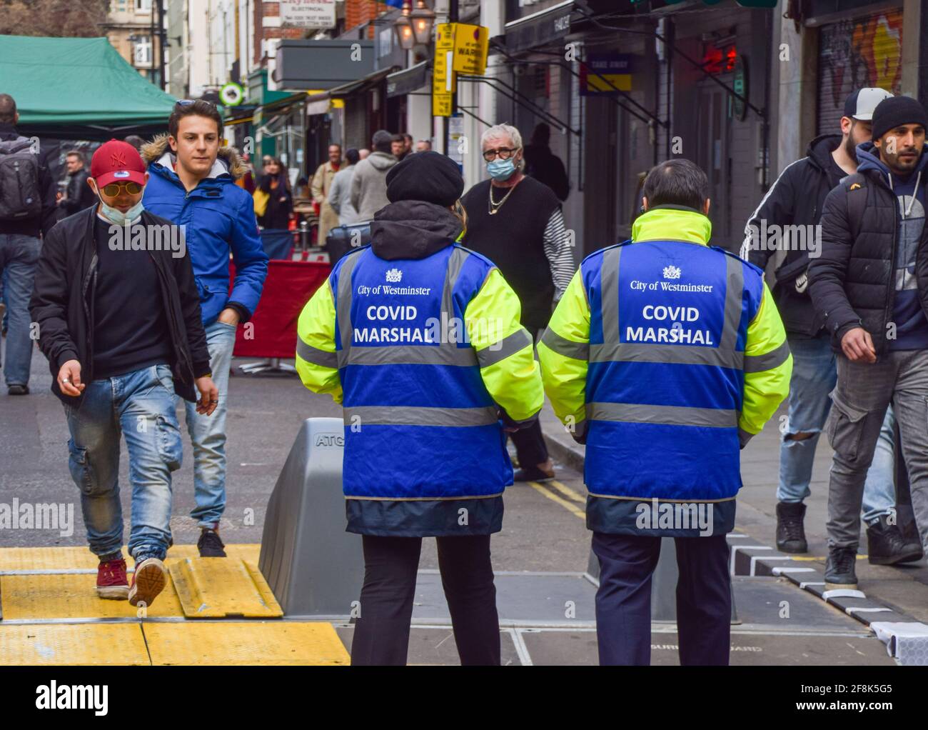 London, United Kingdom. 14th April 2021. Covid Marshals in Old Compton Street, Soho. Marshals have been deployed in the busy streets of Soho to support the public in observing the social distancing rules. Stock Photo