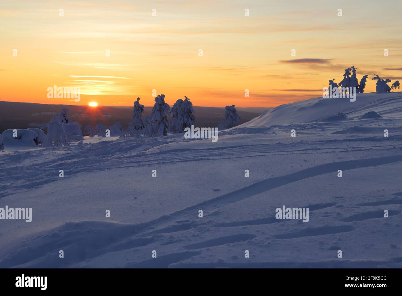 Wintry countryside with sun on horizon in Ylläs in Finnish Lapland Stock Photo