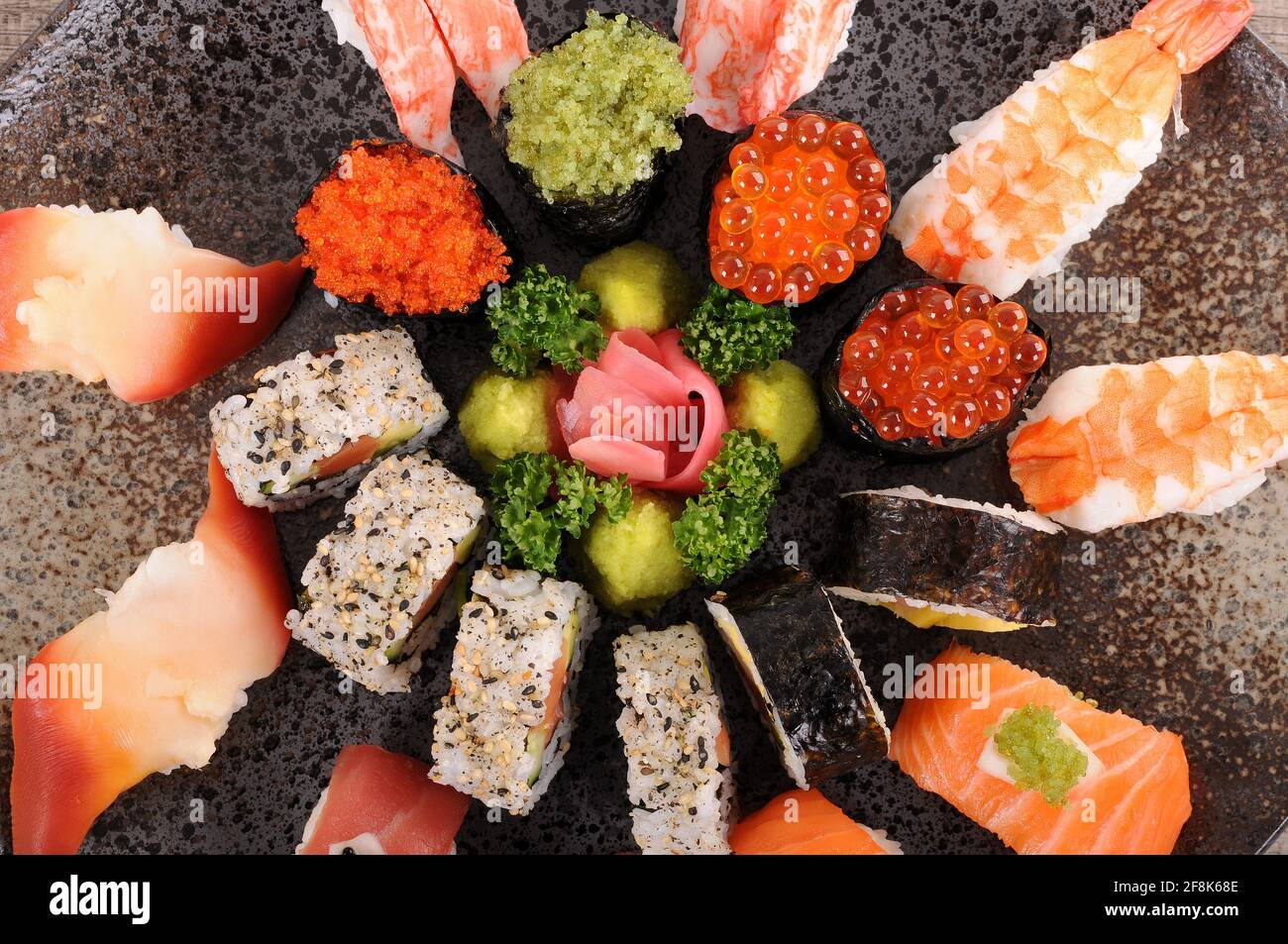 Assorted sushi platter on a black ceramic plate Stock Photo - Alamy