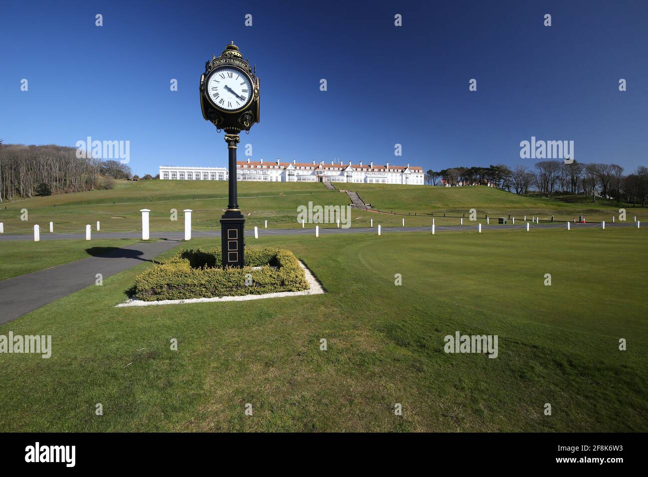 Scotland, Turnberry, Ayrshire, 12 April 2021. Large clock outside Turnberry Club house with the name of Trump on it  & the hotel in the background Stock Photo