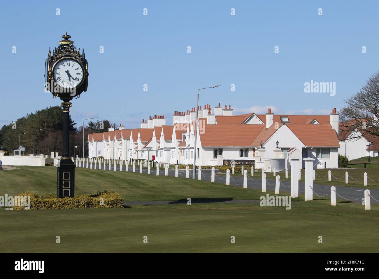 Scotland, Turnberry, Ayrshire, 12 April 2021. Large clock outside Turnberry Club house with the name of Trump on it & lodges in background Stock Photo