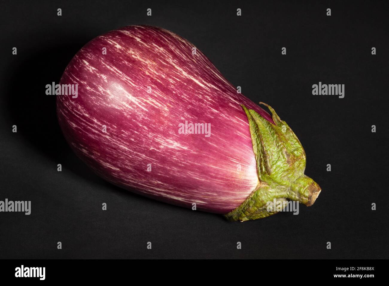 striped eggplant on black background Stock Photo