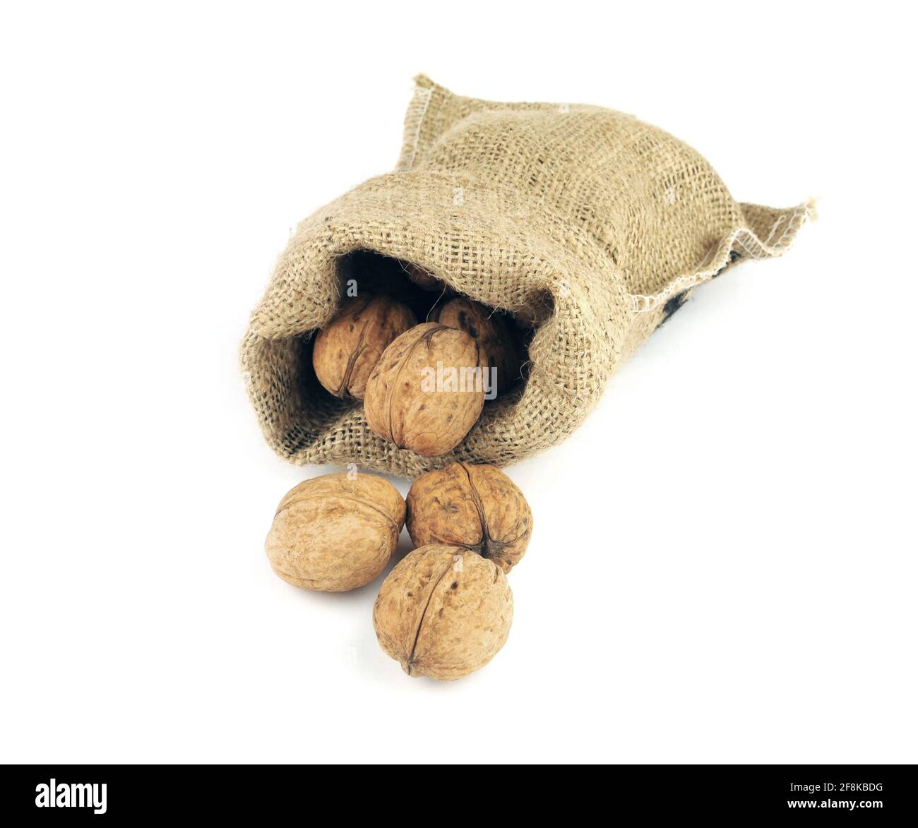 Walnuts in a burlap bag isolated on white Stock Photo