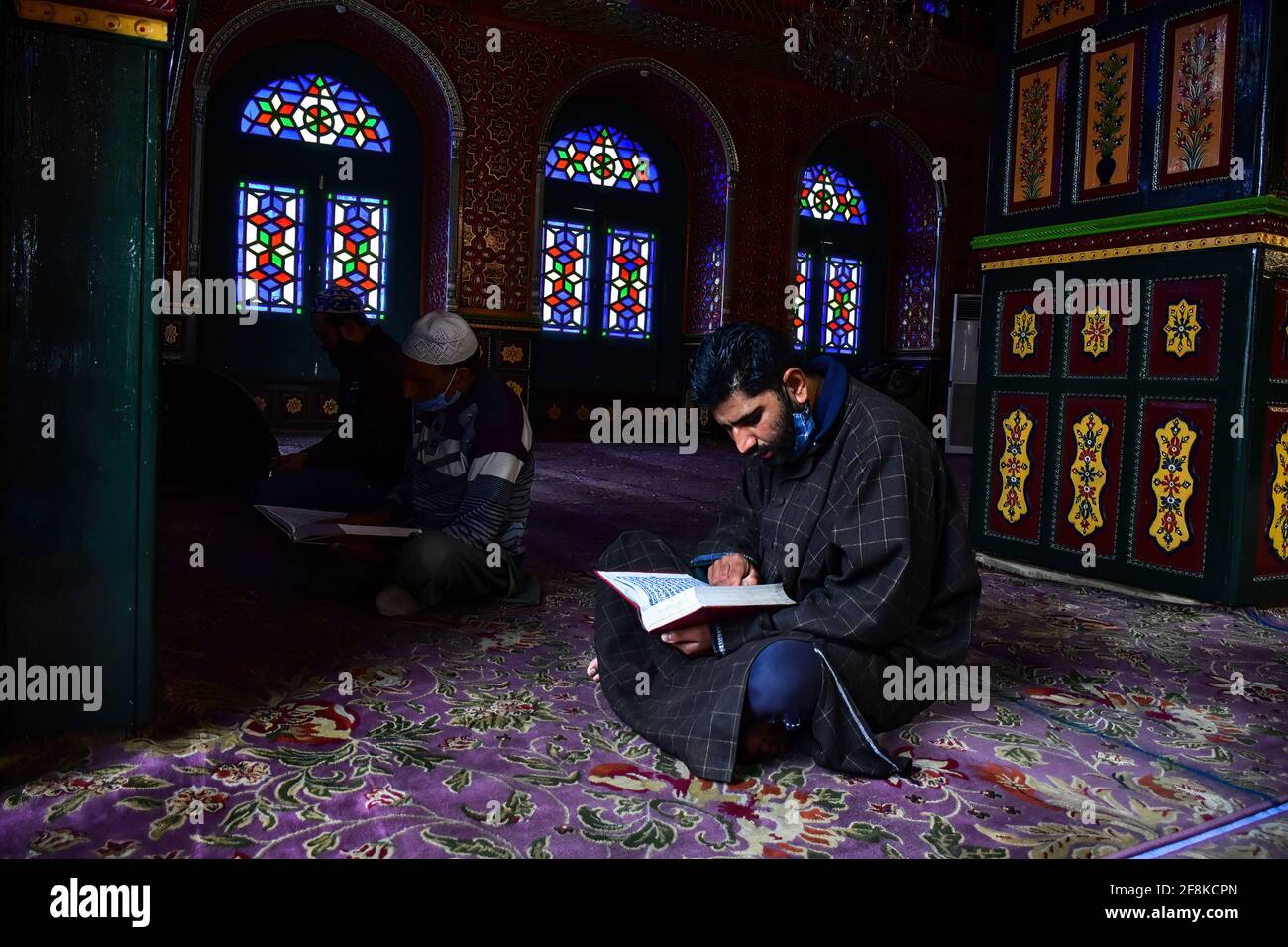A Kashmiri man recites the Holy Quran inside the shrine of Syed Abdul ...