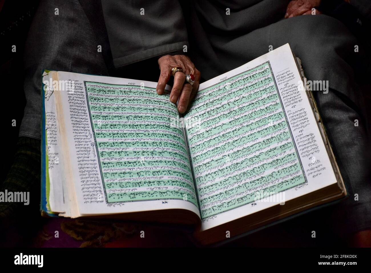 A Kashmiri man recites the Holy Quran inside the shrine of Syed Abdul ...
