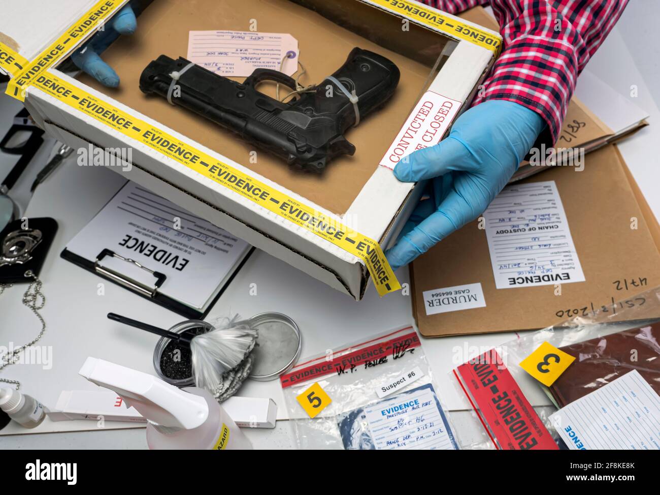 Close up of forensic science evidence box containing gun from crime scene, conceptual image Stock Photo