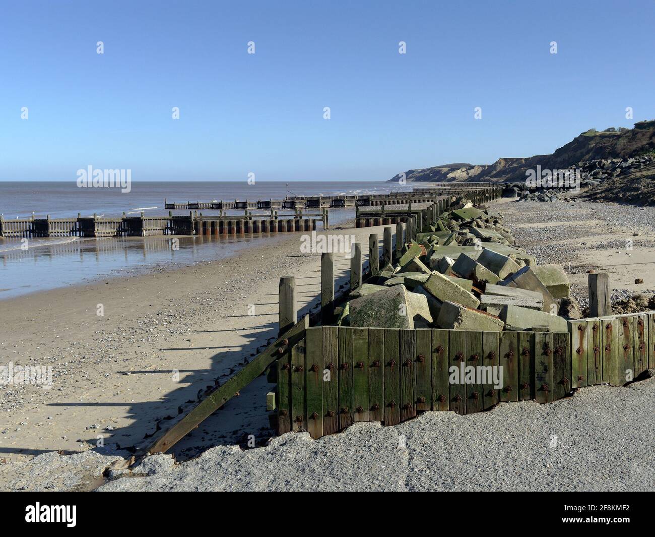 Sea defences protecting the beach and cliffs at the popular residential and holiday village of Overstrand on the North Norfolk coast. Stock Photo