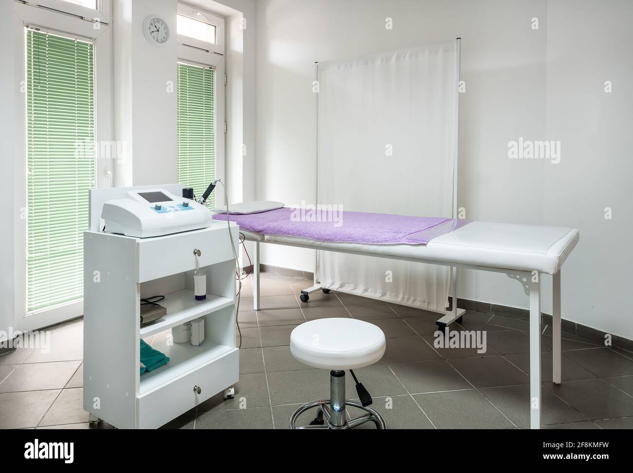 Physician Doctors Office with examination bed and therapy equipment