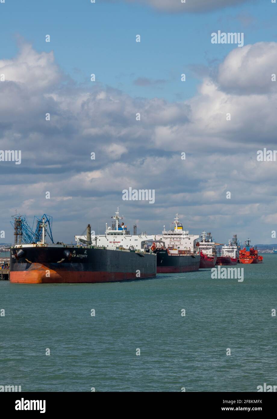 large oil tankers and ships with shipping alongside at the esso fawley marine oil refinery terminal processing plant in southampton docks. Stock Photo