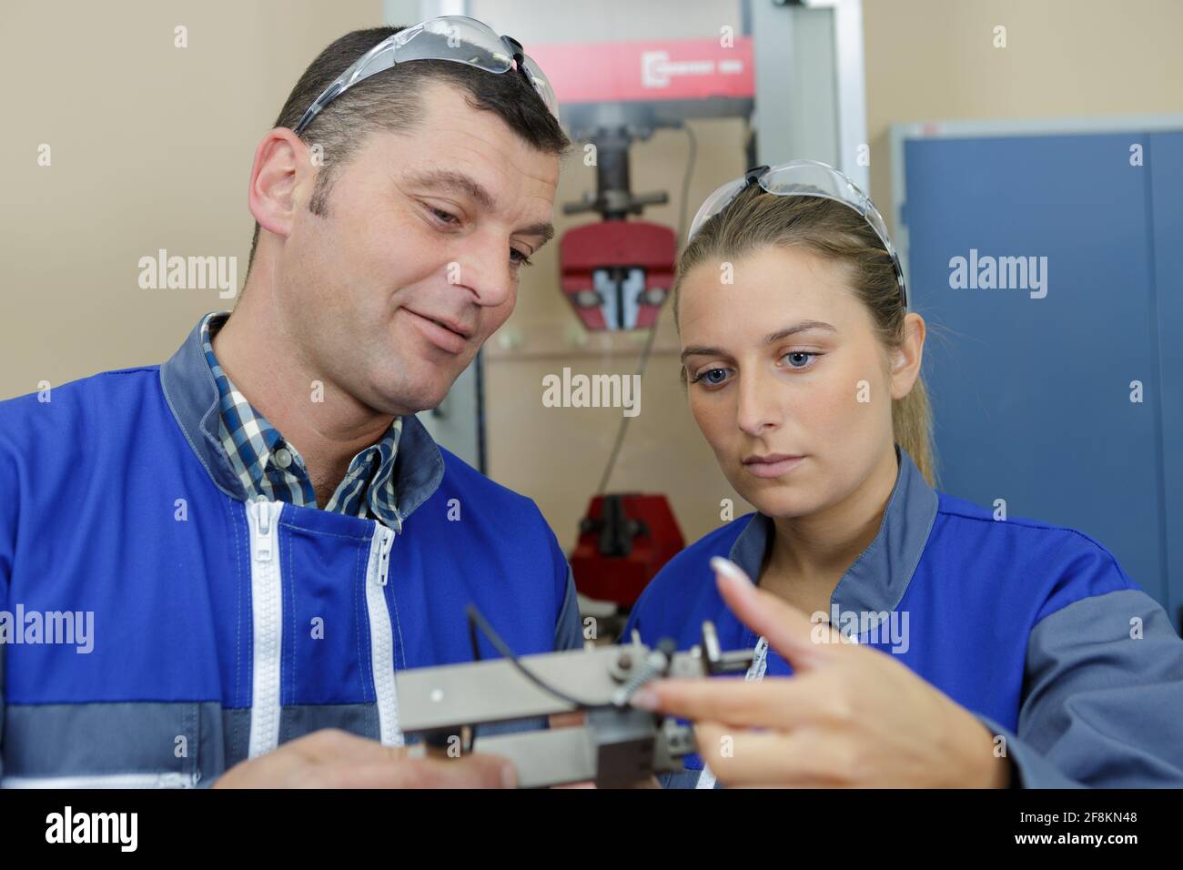 two mechanical robotic apprentices learning Stock Photo - Alamy
