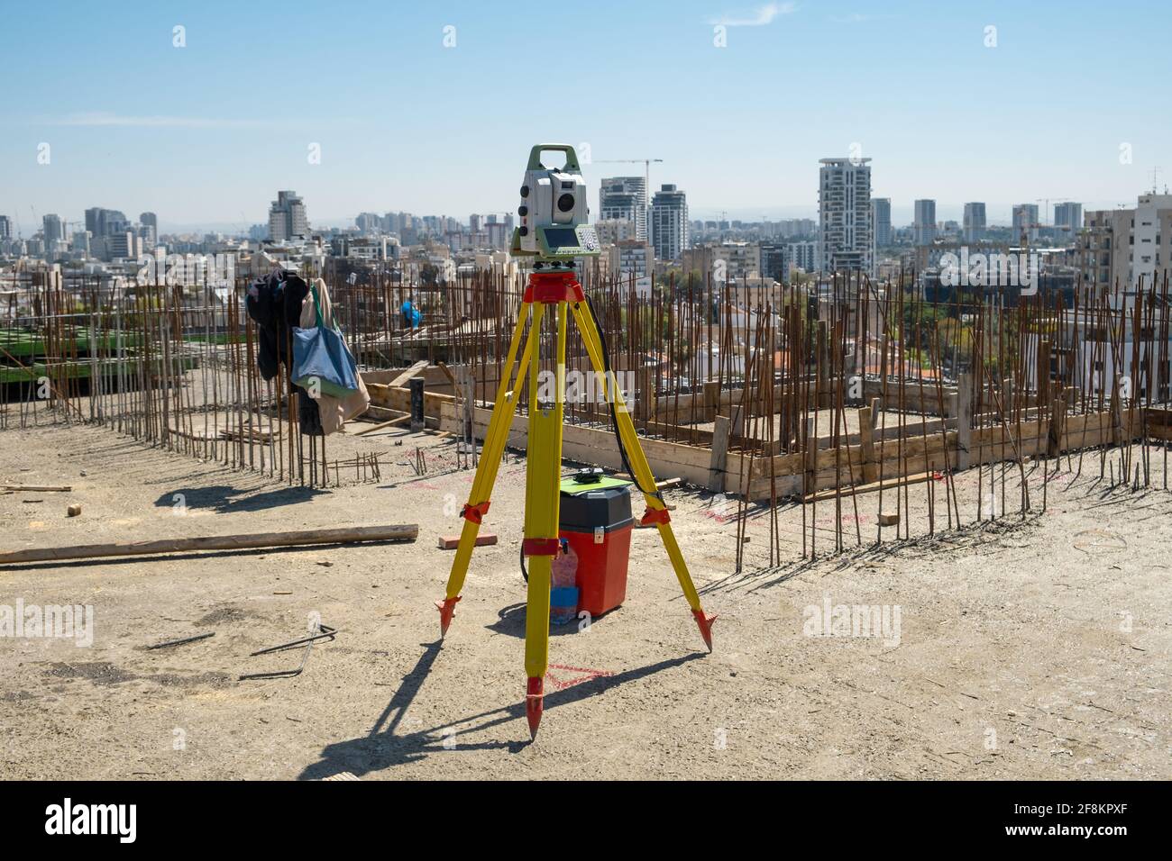 device for geodesy measurement on a construction site against a background of a gray wall Stock Photo
