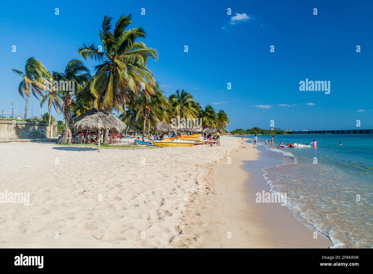 PLAYA GIRON, CUBA - FEB 14, 2016: Tourists at the beach Playa Giron, Cuba. This beach is famous for its role during the Bay of Pigs invasion. Stock Photo