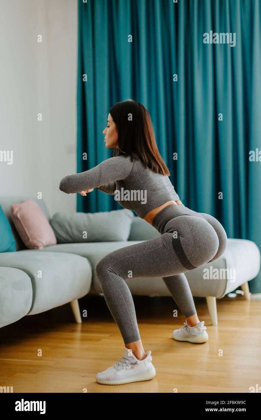 butt workout at home squats with resistance band Stock Photo Alamy
