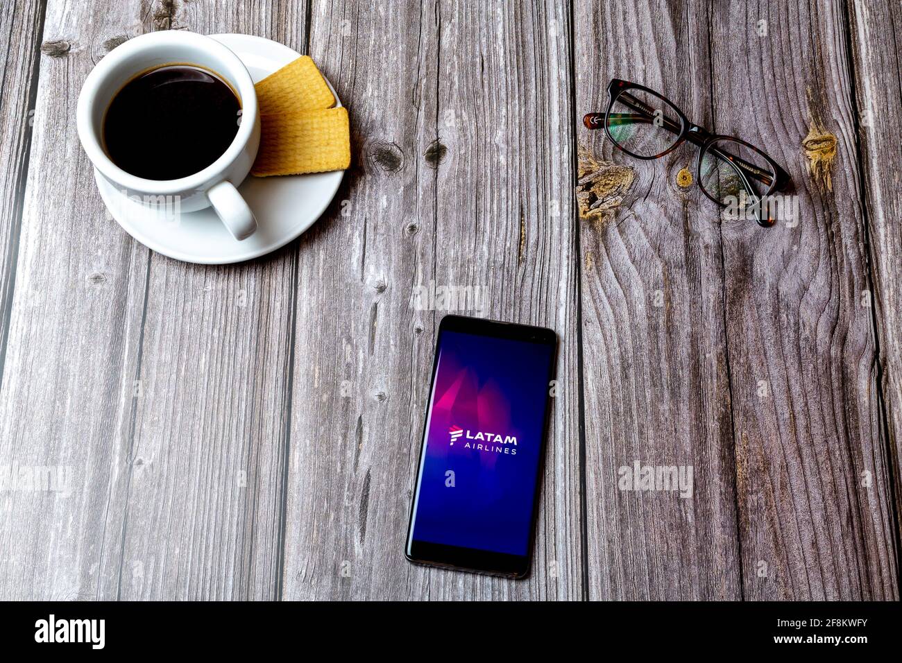 A Mobile phone or cell phone laid on a wooden table showing the Latam ...