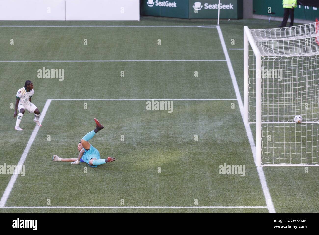 Portland, USA. 13th Apr, 2021. Yimmi Chara (23) gets a third goal past Marathon goalkeeper Denovan Torres. The Portland Timbers trounced Honduras' CD Marathon 5-0 on April 13, 2021 in Portland, Oregon, including a hat trick by Yimmy Chara, in their second meeting in the CONCACAF round of 16. Their first meeting last week in Honduras was a 2-2 tie. (Photo by John Rudoff/Sipa USA) Credit: Sipa USA/Alamy Live News Stock Photo