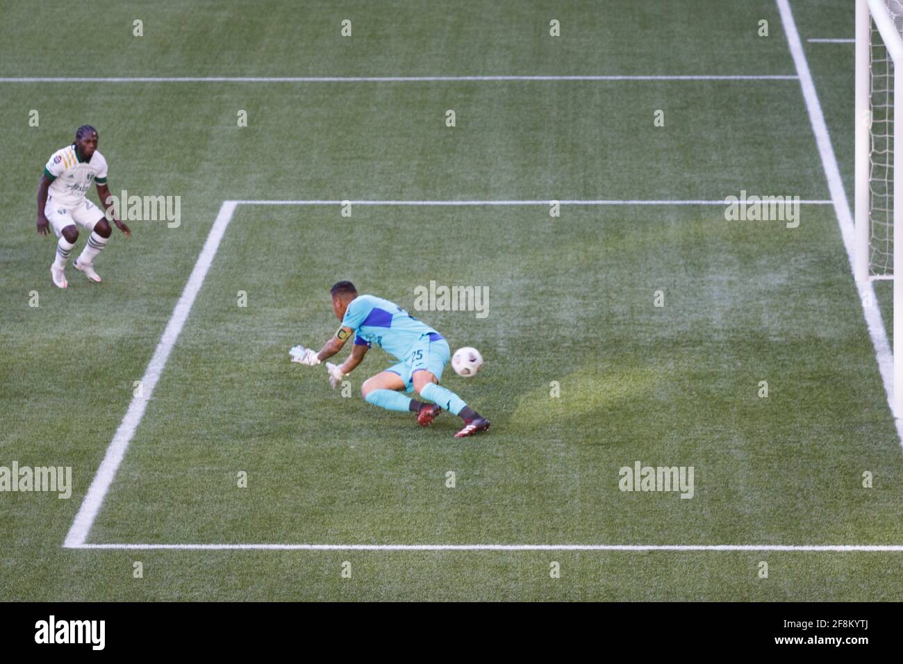 Portland, USA. 13th Apr, 2021. Yimmi Chara (23) gets a third goal past Marathon goalkeeper Denovan Torres. The Portland Timbers trounced Honduras' CD Marathon 5-0 on April 13, 2021 in Portland, Oregon, including a hat trick by Yimmy Chara, in their second meeting in the CONCACAF round of 16. Their first meeting last week in Honduras was a 2-2 tie. (Photo by John Rudoff/Sipa USA) Credit: Sipa USA/Alamy Live News Stock Photo