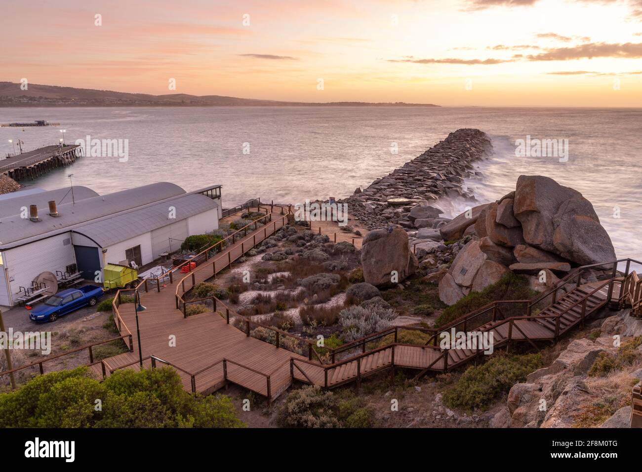 The granite island breakwater and boardwalk at sunrise in Victor Harbor ...