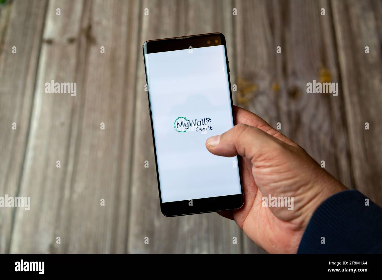 A Mobile phone or Cell phone being held in a hand showing the My Wall