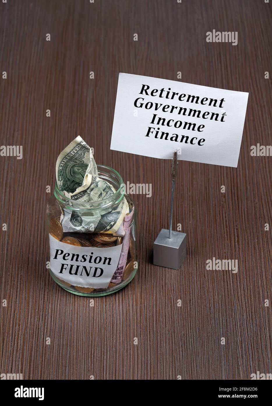 Glass jar with money inside for pension retirement fund Stock Photo
