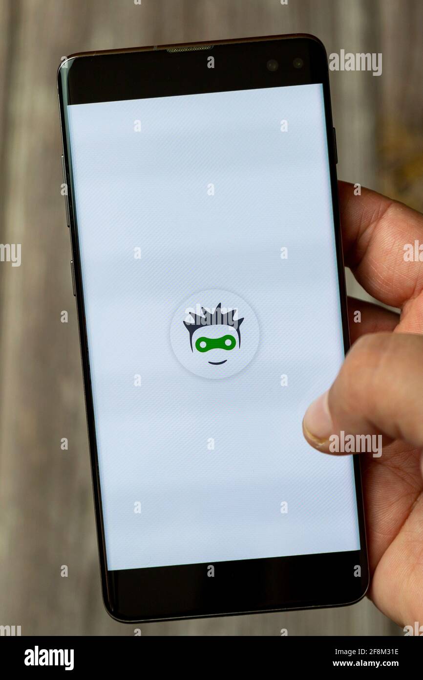 A Mobile phone or Cell phone being held in a hand showing the cyclers UK app on screen Stock Photo