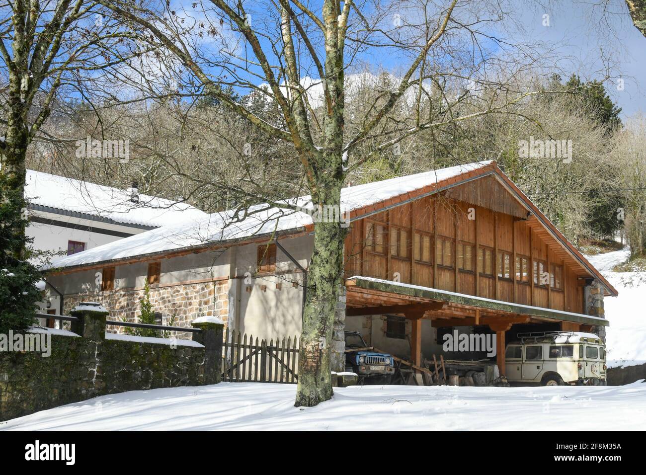 Wooden house in snowy mountain landscape Stock Photo - Alamy