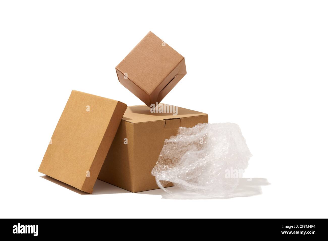 Close-up shot of different shaped cardboard boxes and bubble wrap isolated  on white background Stock Photo - Alamy