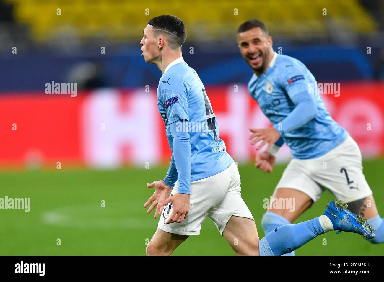 Dortmund, Germany. 14th Apr, 2021. Football: Champions League, knockout round, quarter-finals, second leg, Borussia Dortmund - Manchester City at Signal Iduna Park. Manchester's Phil Foden (l) celebrates with his Manchester City teammate Kyle Walker (r) after scoring the 1:2. Credit: Martin Meissner/AP-Pool/dpa/Alamy Live News Stock Photo
