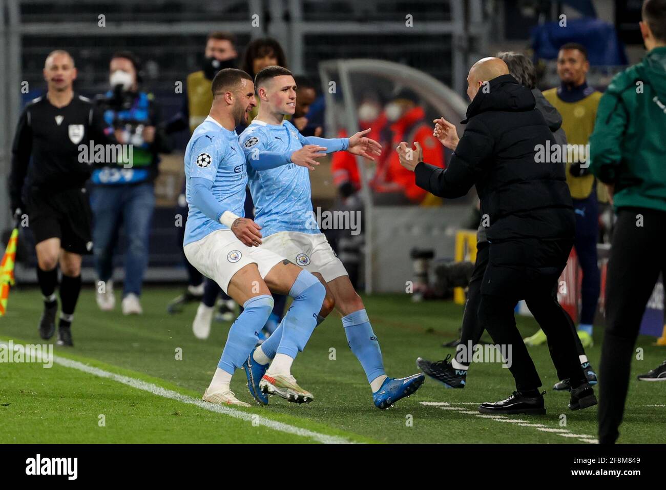 DORTMUND, GERMANY - APRIL 14: Phil Foden of Manchester City celebrating his goal with Coach Pep Guardiola of Manchester City during the UEFA Champions Stock Photo