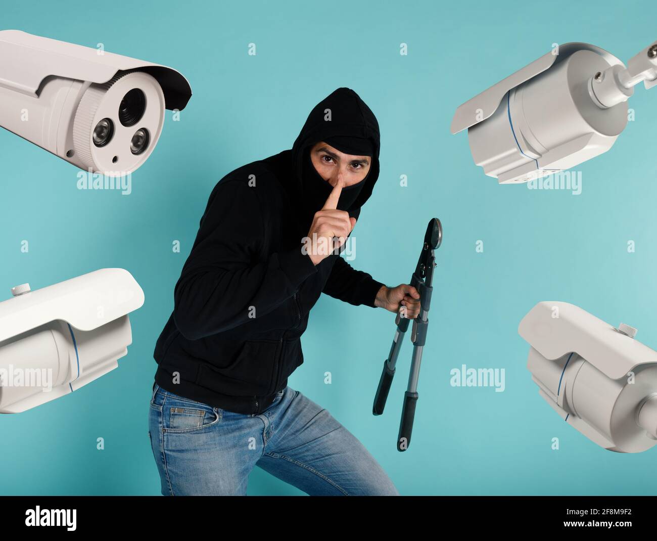 Thief with balaclava was spotted trying to steal in a apartment from the video surveillance system. Stock Photo