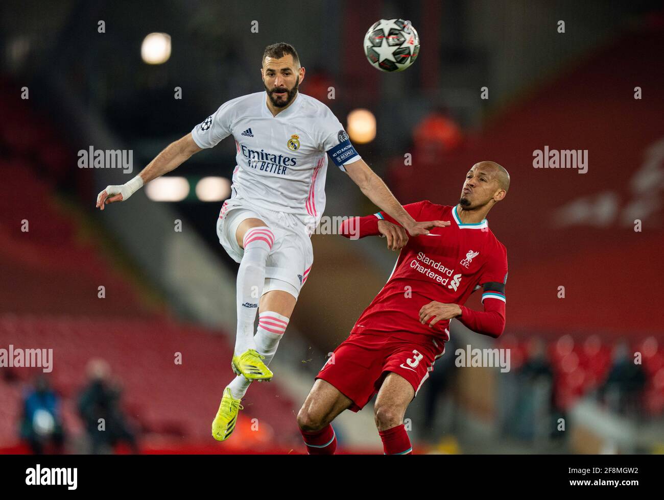 Liverpool. 15th Apr, 2021. Real Madrid's Karim Benzema (L) is challenged by  Liverpool's Fabinho during the UEFA Champions League quarterfinal 2nd Leg  match between Liverpool and Real Madrid at Anfield in Liverpool,