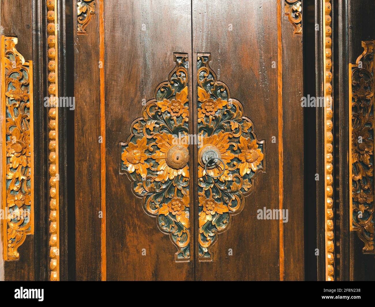 Stunning typical balinese door with wood and golden ornaments Stock