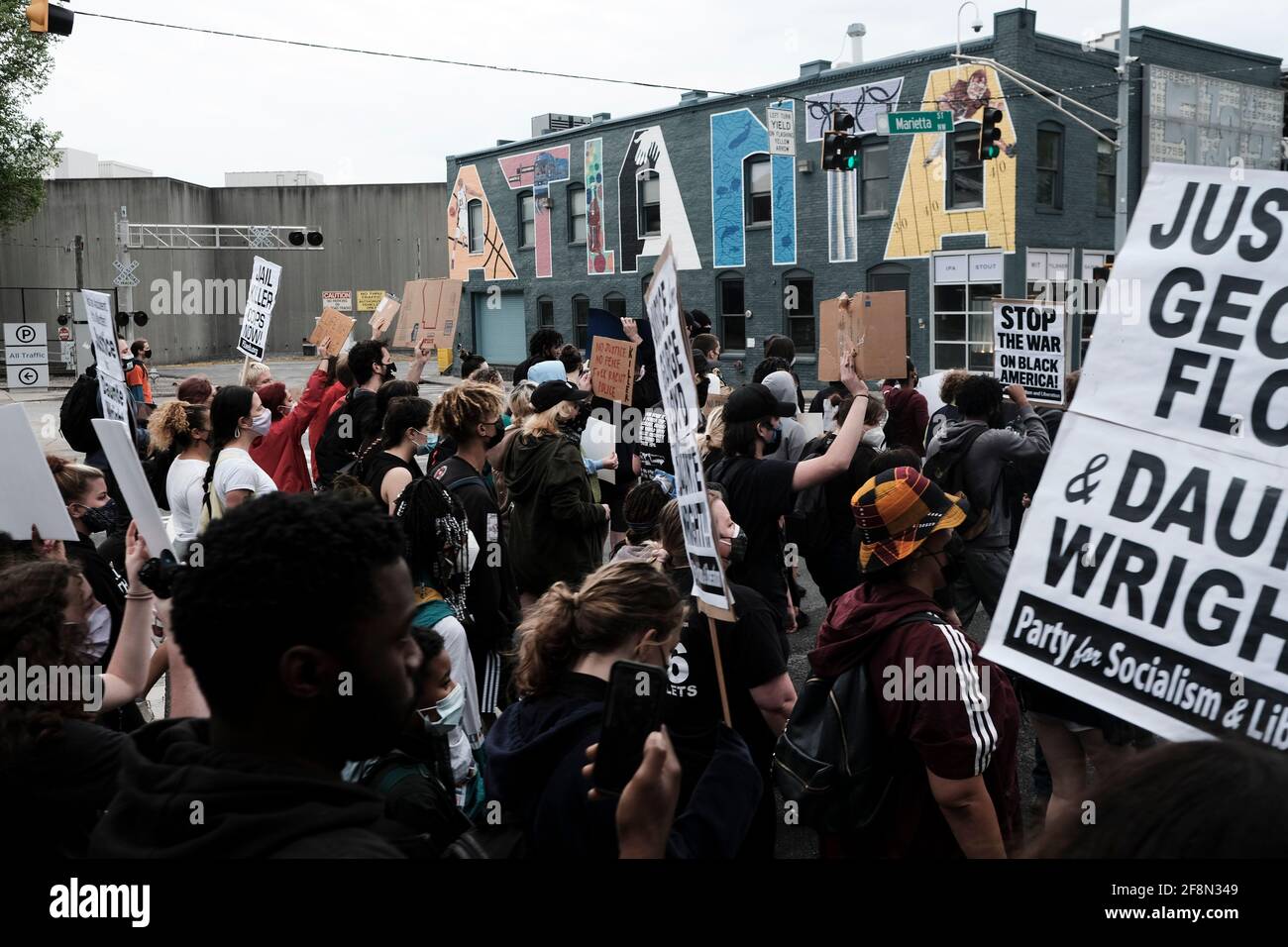 Atlanta, Georgia, USA. 14th Apr, 2021. A group of demonstrators march through downtown Atlanta after a rally for Daunte Wright, the 20 year old black man who was shot and killed by a police officer in Brooklyn Center, Minnesota on April 11. Wright was shot just several miles away from where George Floyd was killed by former Minneapolis police officer Derek Chauvin, whose murder trial is currently underway. The officer who shot Daunte Wright, Kimberly Potter, has since resigned, and has been arrested and charged with second degree manslaughter. Potter shot and killed Wright when she discharg Stock Photo