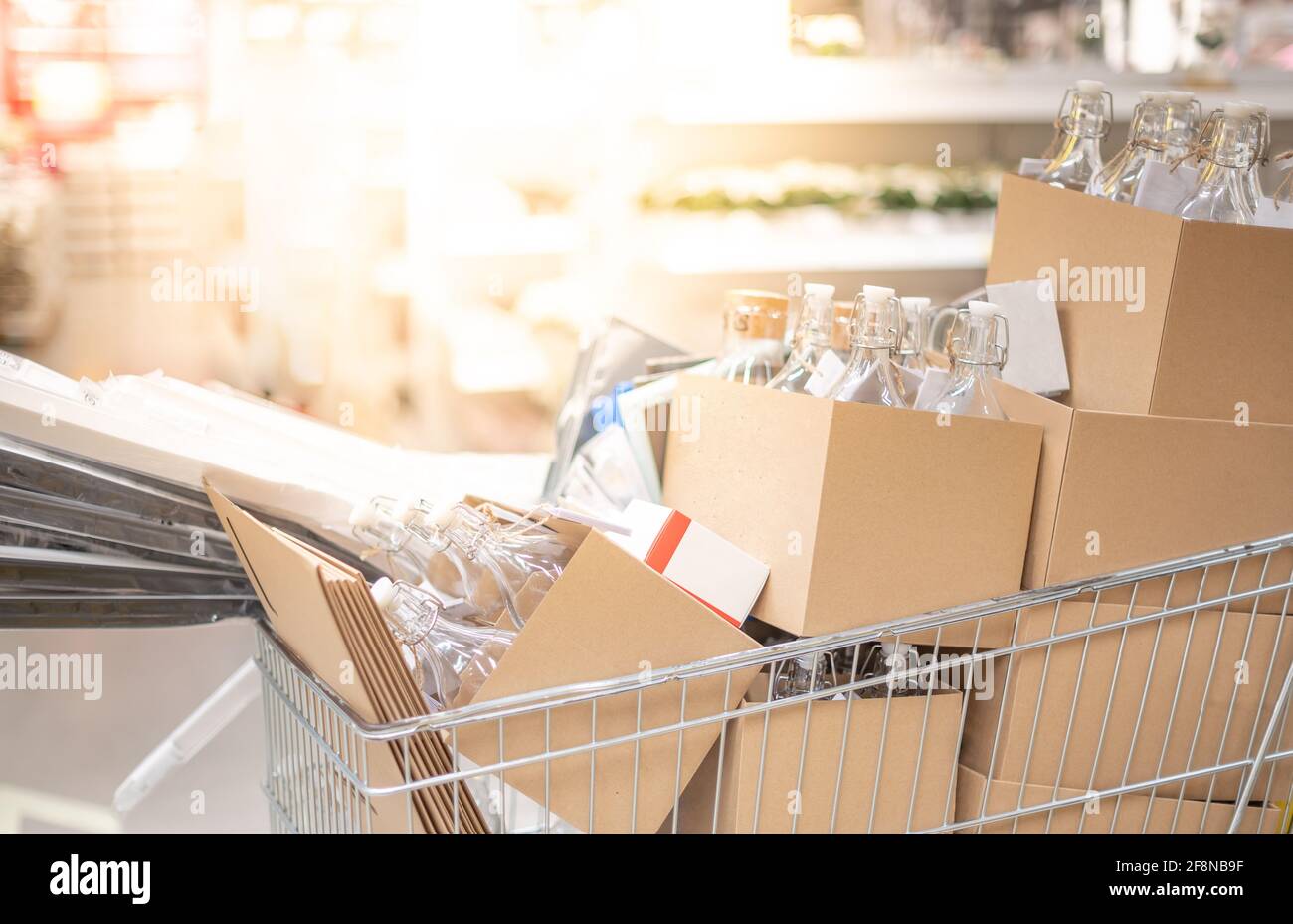 Many carton and glass bottle in the stainless trolley at Supermarket