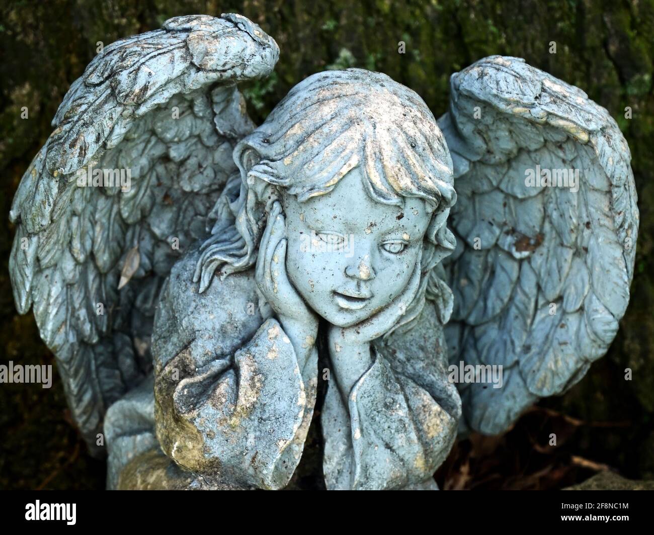 Detail of a weathered angel garden statue. Stock Photo