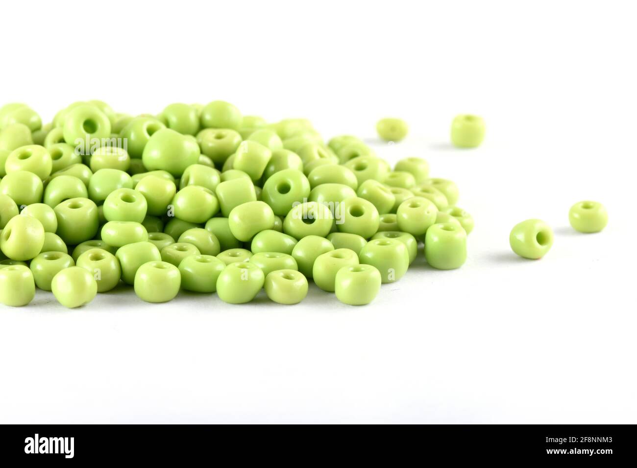 Close up of Light green Beads on the white background Background macro, make bead necklace Stock Photo
