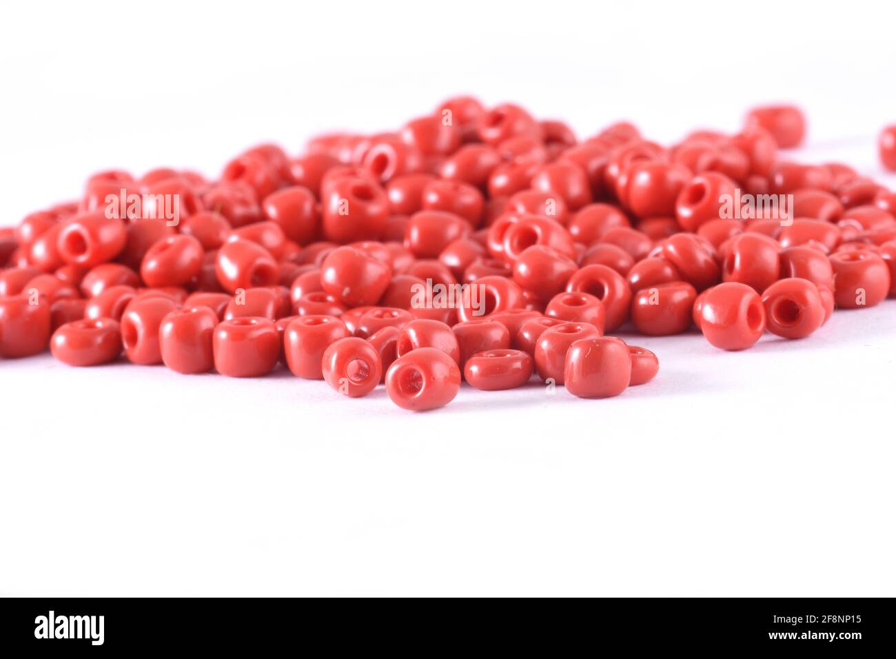 Close up of red Beads on the white background Background macro, make bead necklace Stock Photo